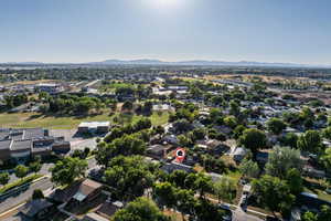 Aerial view of property's location featuring nearby suburban area and a mountainous background