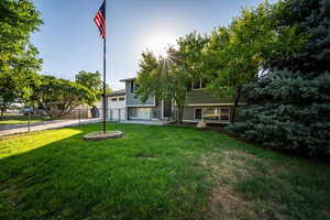 View of front of home with driveway and an attached garage
