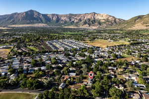 Aerial view of property's location featuring nearby suburban area and mountains