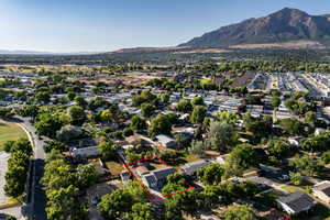 Aerial perspective of suburban area featuring property parcel outlined and a mountain backdrop