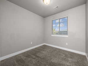 Carpeted empty room with baseboards