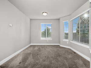 Spare room featuring carpet
