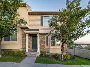 View of front of house with stone siding