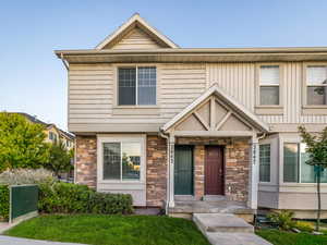 View of front of house featuring stone siding and stucco siding