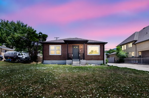 Bungalow-style house featuring brick siding, roof with shingles, and entry steps