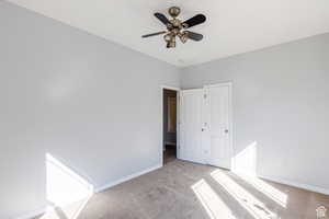 Unfurnished bedroom featuring carpet and a ceiling fan