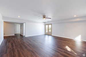 Unfurnished room featuring ceiling fan, dark wood finished floors, recessed lighting, and french doors