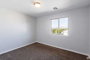 Unfurnished room with dark carpet and a mountain view