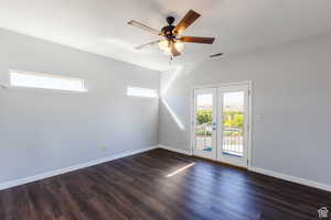 Empty room with dark wood-type flooring and a ceiling fan