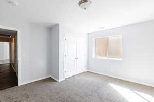 Unfurnished bedroom featuring carpet floors and a closet