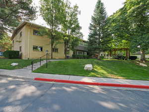 View of front of property with brick siding and a front yard