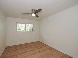 Spare room featuring light wood finished floors and a ceiling fan