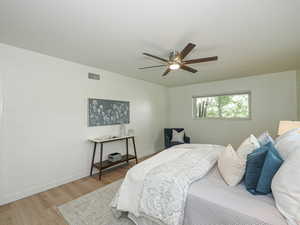 Bedroom with wood finished floors and ceiling fan