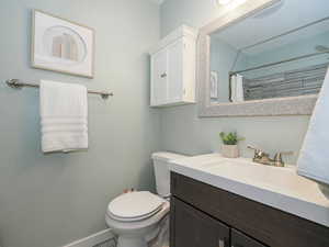 Bathroom with vanity and curtained shower