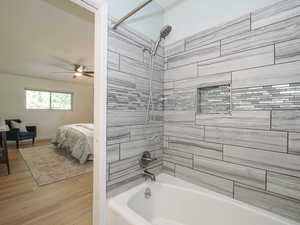 Ensuite bathroom featuring shower / bath combination, wood finished floors, and ceiling fan