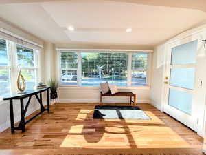 Living area featuring light wood-type flooring and recessed lighting