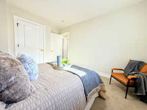 Carpeted bedroom featuring baseboards