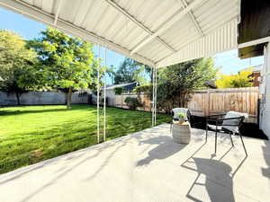 Fenced backyard with a patio area