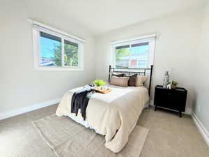 Bedroom featuring light carpet