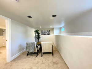 Sitting room with carpet floors and recessed lighting