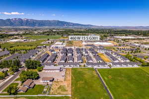 Aerial overview of property's location with a mountainous background and nearby suburban area