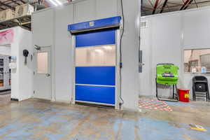 Garage featuring baseboards