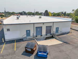 View of property with uncovered parking and entry steps