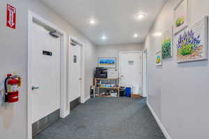 Hallway with carpet floors and recessed lighting