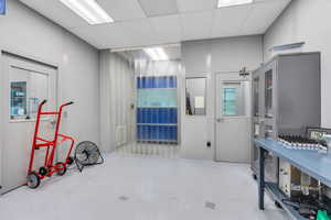 Misc room with finished concrete floors and a paneled ceiling