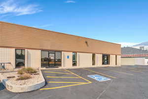 View of building exterior with uncovered parking