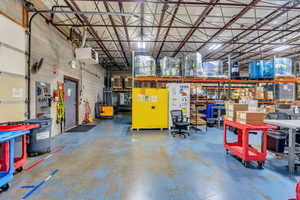 Garage featuring a heating unit and metal wall