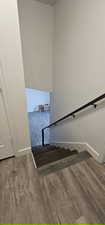 Stairway featuring wood finished floors and baseboards