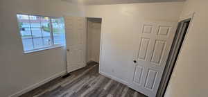 Unfurnished bedroom featuring dark wood-style floors and a textured ceiling
