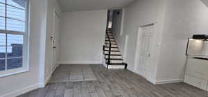 Foyer with wood tiled floors and stairs