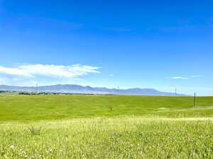 View of mountain backdrop featuring rural landscape