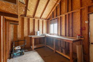 View of storage room with plenty of room for hobby or sport equipment and built in work bench