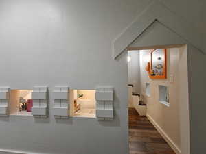 Hallway featuring wood finished floors and baseboards