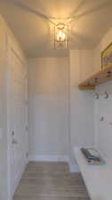 Mudroom featuring wood finished floors and baseboards