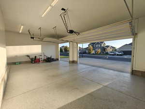 Garage featuring a residential view and a garage door opener