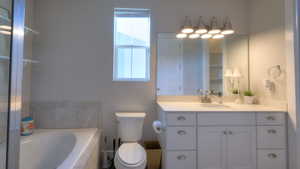 Full bathroom with a garden tub and vanity