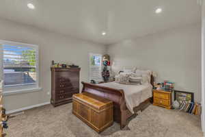 Carpeted bedroom featuring recessed lighting and baseboards