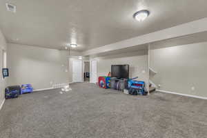 Game room featuring baseboards and carpet floors