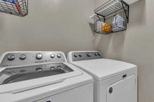 Laundry room with washer and clothes dryer