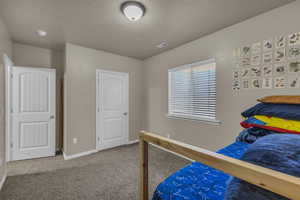 Carpeted bedroom featuring baseboards