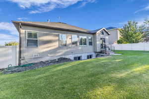 Rear view of property with a fenced backyard and stucco siding