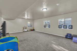 Rec room featuring carpet and baseboards
