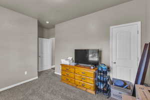 Carpeted bedroom featuring baseboards