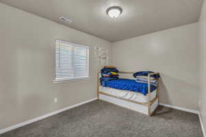 Bedroom featuring carpet flooring and baseboards