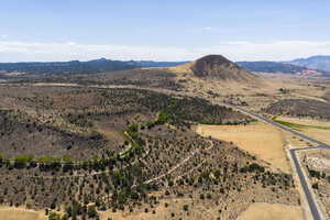 View of mountain backdrop with rural landscape and a desert landscape