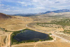 Aerial overview of property's location with a mountain backdrop and rural landscape